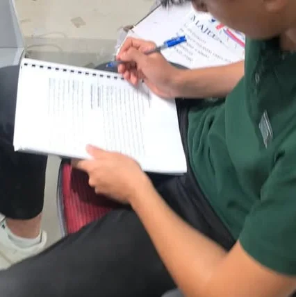 Basheer studying in his work uniform