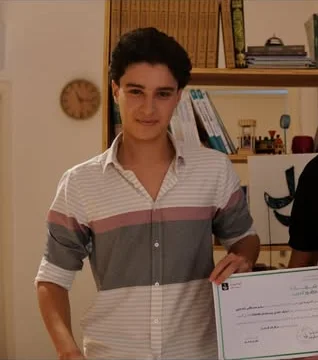 Basheer holding his Claude certificate from Nool Academy
